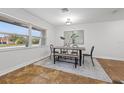 Sunlit dining area showcasing a modern table and chair set, complemented by a neutral color palette at 2214 Wilshire Dr, Dunedin, FL 34698
