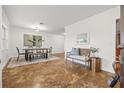 Bright dining room featuring a stylish table setting, ample lighting, and warm toned flooring at 2214 Wilshire Dr, Dunedin, FL 34698