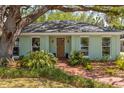 Charming single-story home with a lush front yard and inviting brick walkway at 2304 S Occident St, Tampa, FL 33629