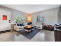 Bright living room featuring a plush sectional sofa, stylish rug, and ample natural light at 2808 W Lake Ave, Tampa, FL 33607
