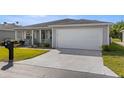 Well-maintained single-story home with a wide driveway, manicured lawn, and a two-car garage at 29408 Princeville Dr, San Antonio, FL 33576