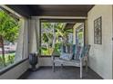 Enclosed porch offering a tranquil spot to relax and enjoy the view at 307 Bay St, Tarpon Springs, FL 34689