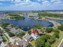 Wide aerial view showing a neighborhood set beside a large lake with lush greenery at 308 Manns Harbor Dr, Apollo Beach, FL 33572