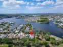 Aerial view showcasing a waterfront community with houses nestled around a tranquil lake at 308 Manns Harbor Dr, Apollo Beach, FL 33572