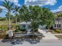 Beautiful single-Gathering home featuring a charming front porch and well-manicured lawn at 308 Manns Harbor Dr, Apollo Beach, FL 33572