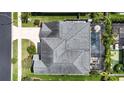 Overhead view of the home showcasing the roof, backyard pool, and patio at 32203 Wenlock Loop, Wesley Chapel, FL 33543