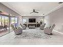 Bright and airy living room with tile floors, ceiling fan, and comfortable recliners at 32203 Wenlock Loop, Wesley Chapel, FL 33543