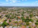 Wide aerial shot highlighting the property's location within a residential neighborhood with lush greenery at 6470 28Th N Ter, St Petersburg, FL 33710