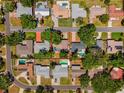 Aerial view of the property showcasing the home's layout, landscaping, and proximity to neighboring houses at 6470 28Th N Ter, St Petersburg, FL 33710