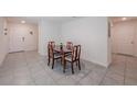 Cozy dining room featuring tile floors and a classic wooden table with seating for four at 659 Sunlit Coral St, Ruskin, FL 33570