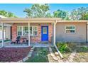 Charming home featuring a bright blue front door and inviting brick-accented porch at 700 16Th Nw St, Largo, FL 33770
