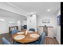 Bright dining room with modern decor, wood floors, and seating for four next to the cozy living room at 7202 8Th N Ave, St Petersburg, FL 33710