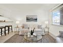 Inviting living room featuring a comfortable couch, accent tables, and plenty of natural light at 7645 Sun Island S Dr # 204, South Pasadena, FL 33707