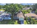 An overhead shot of a single-story home with green grass and mature trees at 7919 64Th N St, Pinellas Park, FL 33781