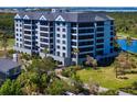 Exterior showcases a well-maintained light blue condominium with meticulous landscaping, offering luxurious curb appeal at 14810 Rue De Bayonne # 2D, Clearwater, FL 33762