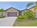 Charming single-story home with a two car garage, manicured lawn and mature palms at 1612 Cabbage Key Dr, Ruskin, FL 33570