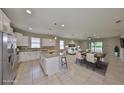 Bright, open-concept kitchen featuring white cabinets, stainless steel appliances, and an island with granite countertops at 1612 Cabbage Key Dr, Ruskin, FL 33570