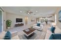 Staged, open-concept living room flows into modern kitchen with stainless steel appliances at 1612 Cabbage Key Dr, Ruskin, FL 33570