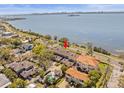 Aerial view showcases bay-front condo community with mature landscaping and beautiful water views at 2087 Edgewater Dr # C, Clearwater, FL 33755