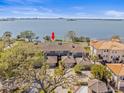 Aerial view of a bay-front complex, showcasing mature trees, landscaping, and beautiful water views at 2087 Edgewater Dr # C, Clearwater, FL 33755