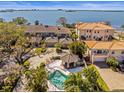 Beautiful aerial view of residences featuring a shared pool, spa and bay views at 2087 Edgewater Dr # C, Clearwater, FL 33755
