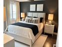 Modern bedroom featuring a neutral color palette, comfortable king-size bed, and stylish bedside tables with elegant lamps at 2511 N Grady Ave # 82, Tampa, FL 33607
