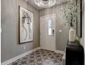 Inviting foyer featuring decorative tile flooring, modern light fixture, and stylish decor at 2511 N Grady Ave # 82, Tampa, FL 33607