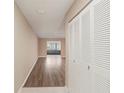 Hallway with wood floor and closet at 2529 Lancaster Dr, Sun City Center, FL 33573