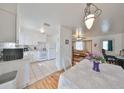 Open kitchen view showcasing white appliances, a dining area, and seamless access to the living room at 3491 58Th N St, St Petersburg, FL 33710
