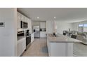 Bright white kitchen with stainless steel appliances and granite countertops at 35260 Spruce Knob Ct, Dade City, FL 33525