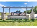 Stone entrance sign to Summit View community with blue sky background at 35260 Spruce Knob Ct, Dade City, FL 33525