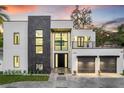 A modern two-story house showcases clean lines, a balcony, and a well-maintained front yard at 3604 W El Prado Blvd, Tampa, FL 33629