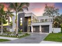 Striking modern home with a two-car garage, balcony, and tastefully landscaped front yard at 3604 W El Prado Blvd, Tampa, FL 33629