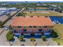 Stunning aerial view of a multi-story residence with a tile roof, landscaping, and a golf course nearby at 47 W Morgan St, Tarpon Springs, FL 34689