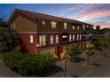 Elegant multi-story residence with a tile roof, black awnings, and lush tropical landscaping at 47 W Morgan St, Tarpon Springs, FL 34689