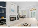 Open-concept living room with fireplace, natural light and clear views into the adjacent dining area at 5004 Waterkey Way, Tampa, FL 33647