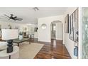 Bright and open living room with hardwood floors, neutral decor, and seamless flow to kitchen at 601 Boca Ciega Isle Dr, St Pete Beach, FL 33706