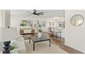 Stylish living room featuring hardwood floors, neutral decor, and natural light with access to the dining area at 601 Boca Ciega Isle Dr, St Pete Beach, FL 33706
