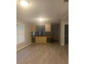 Living area featuring open bar to kitchen with wood-look floors and natural light at 6200 N 44Th St, Tampa, FL 33610