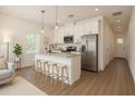Modern kitchen features stainless steel appliances, island with bar seating, and bright natural light at 9002 Glenarm Way, Spring Hill, FL 34613