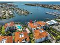 Stunning aerial shot of condos with boat docks, waterfront views, and a refreshing community pool at 1038 Bellasol Way # 202, Apollo Beach, FL 33572