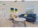 Comfortable living room featuring modern furniture and plenty of natural light from a nearby window at 125 11Th Ave, Indian Rocks Beach, FL 33785