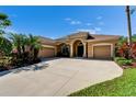 Stunning single-story home with a well-manicured lawn, mature trees, and a circular driveway at 12903 49Th E Ln, Parrish, FL 34219