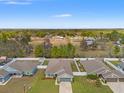 Aerial view of a home with a fenced backyard and surrounding greenery and neighboring properties at 16302 Vine Cliff Ave, Hudson, FL 34667