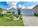 Charming single-story home boasts a meticulously landscaped front yard, enhancing its curb appeal at 16934 Oval Rum Dr, Wimauma, FL 33598