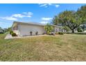 Well-maintained home showcasing a spacious yard and mature landscaping at 1901 Canterbury Ln # 14, Sun City Center, FL 33573