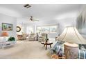 Bright living room with large windows and comfortable seating area at 1901 Canterbury Ln # 14, Sun City Center, FL 33573