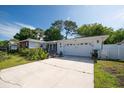 Inviting one-story home with a well-maintained lawn, mature trees, and attached two-car garage at 2087 59Th N St, Clearwater, FL 33760