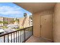 A balcony overlooking the street with a view of palm trees and nearby buildings at 2614 Cove Cay Dr # 301, Clearwater, FL 33760