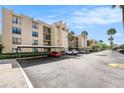 Low angle exterior shot of a condominium building with a parking area at 2614 Cove Cay Dr # 301, Clearwater, FL 33760